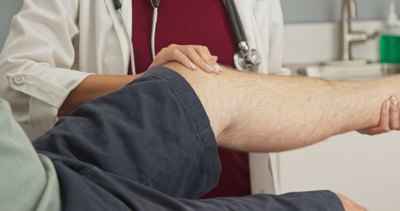 Man's knee being examined by a doctor