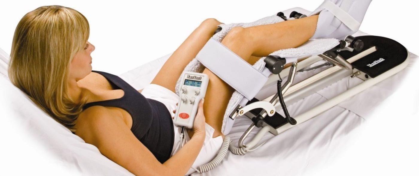 Woman's leg strapped in to Continuous Passive Motion machine